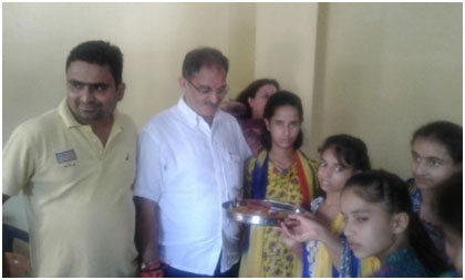 Kavinder Gupta  Hon'ble Speaker J&K Legislative Assembly Celebrating Raksha Bandhan with Girl Inmates of  Balgran in its premises. Girl inmate's tieing Rakhi to Sh. Gupta.